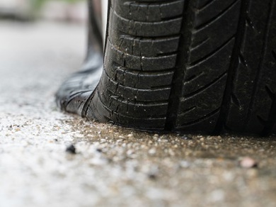 Close up of a flat car tyre
